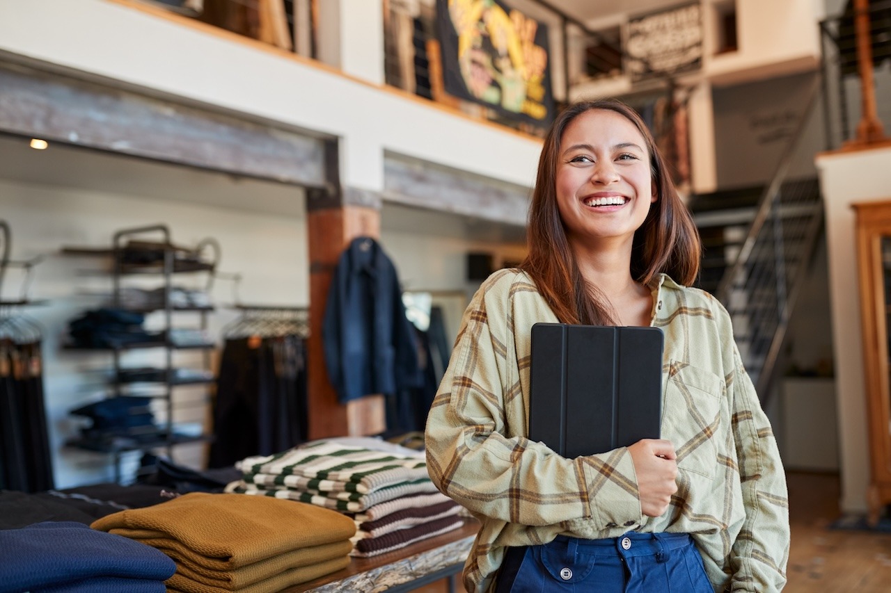 Small business owner smiling about High-Yield Business Checking